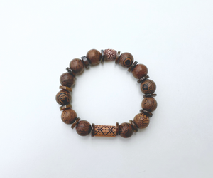 Wooden bead bracelet with thin shiny brown shells.